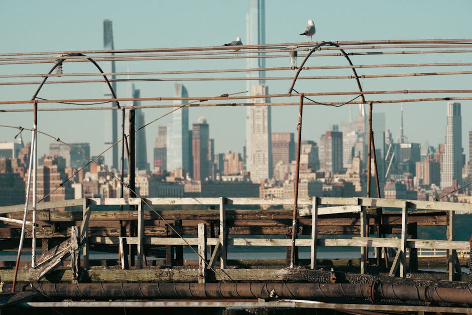 A rustic pier foreground with the vibrant New York City skyline in the background.