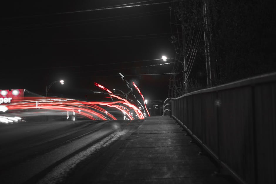 A captivating long exposure shot of light trails on a bridge at night, emphasizing motion and speed.