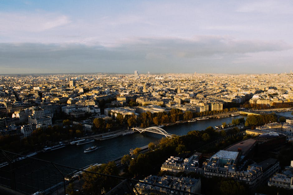 A breathtaking aerial view of Paris with the Seine River and iconic cityscape at sunset.