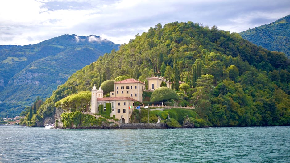 Scenic view of Villa del Balbianello nestled on Lake Como surrounded by lush greenery.